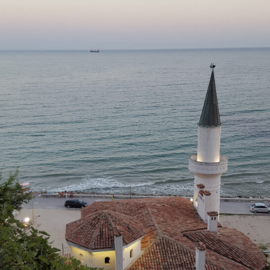 A photo from the hill above Balchik Palace Bulgaria, overlooking the blue green waters of the Black sea at sunset.