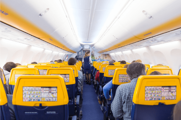 Inside of a RyanAir aircraft, everything is in their colours of yellow and navy.