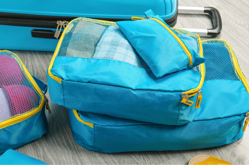 A stack of blue packing cubes