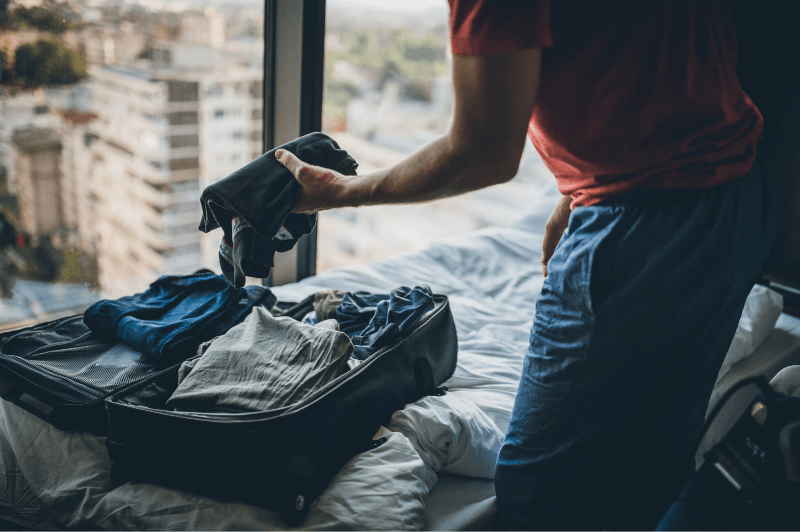 a man packs a small suitcase