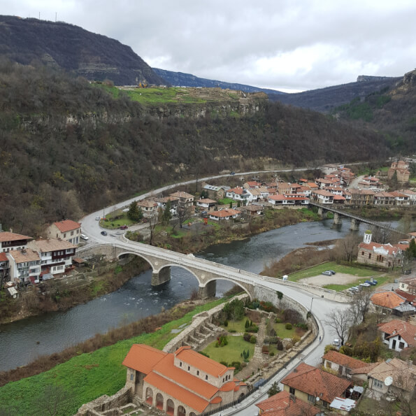 Aerial view of a bridge and little houses by the river in Veliko Tarnovo
