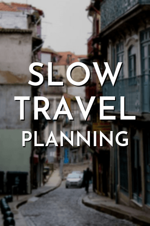 Text reads "Slow Travel Planning" over a faded background of a narrow street of row houses in Porto Portugal