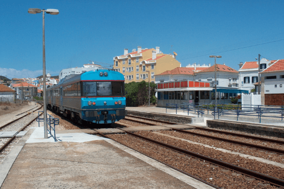 A blue train pulls into a station in a town in Northern Portugal