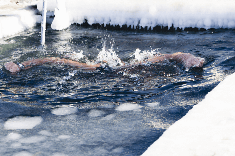 A swimmer swims through icy chunks in open water like Bulgarians at Iordanov Den