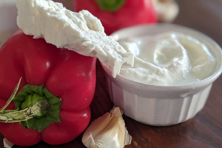 Bulgarian cheese and yogurt beside a red pepper and garlic - katak ingredients