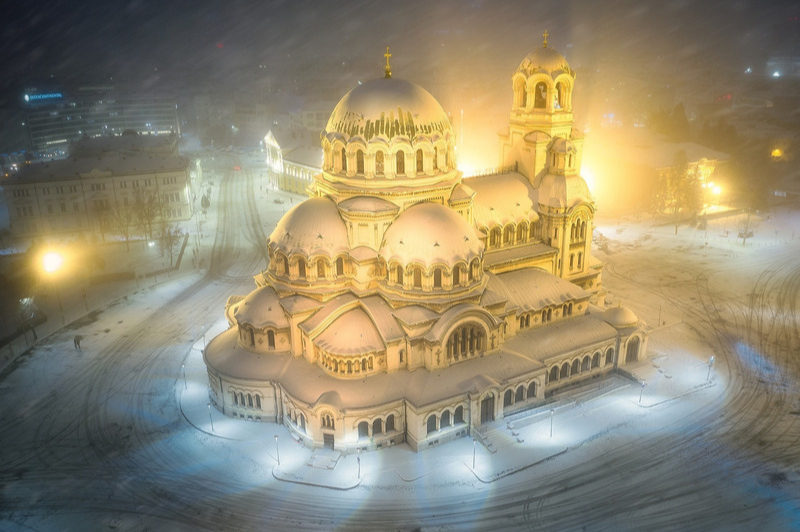 A snowy night view of Alexander Nevsky Cathedral - a multi domed orthodox church in Sofia Bulgaria. Photo by Sviretsov Photography