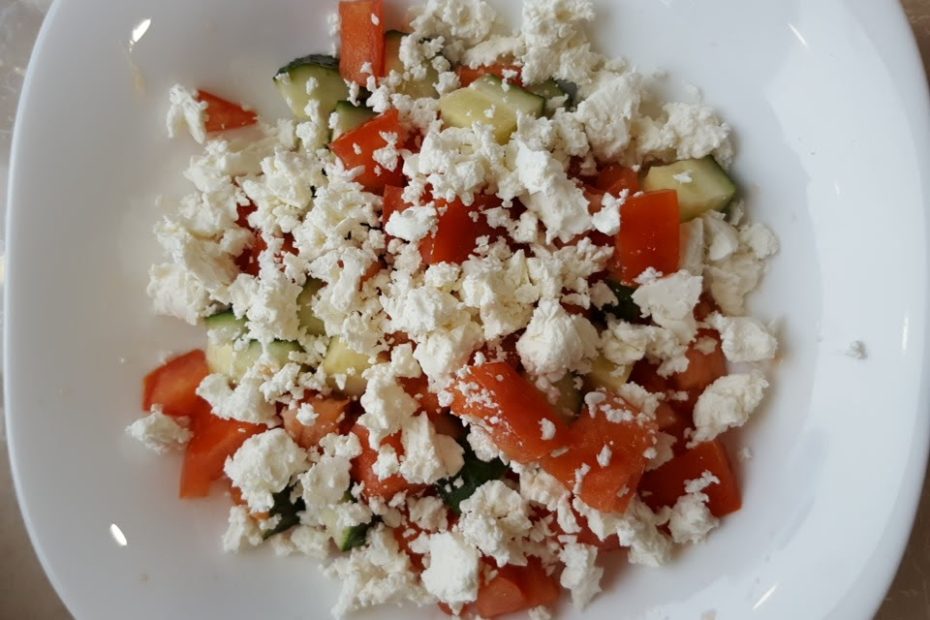 Shopska salad in Bulgaria. Tomatoes, red pepper, cucumber and crumbled white cheese.