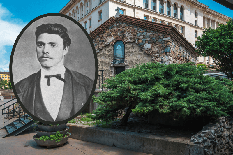 An old black and white portrait of Vasil Levski in front of a background of the medieval church of St. Petka and the Saddlers in Sofia Bulgaria. A small peaked roof stone church with green shrubs out front is rumored to be the place that Vasil Levski was buried.