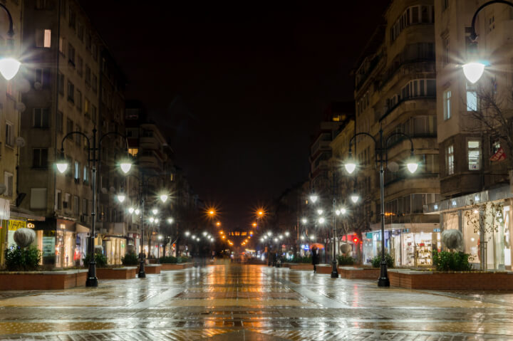 Vitosha boulevard lights at night reflected in the rain.