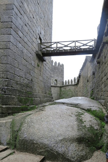 Drawbridge between Guimaraes Castle and the Castle wall, with a natural boulder underneath