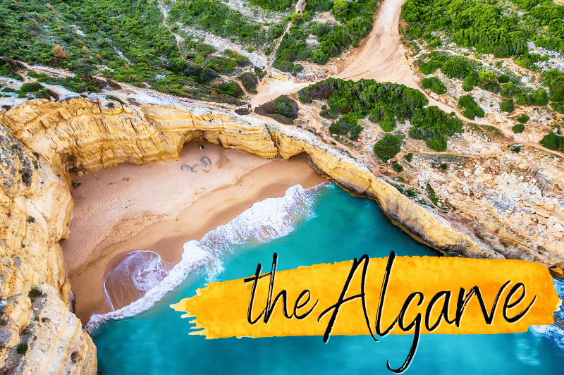 A sandy beach with turquoise waters in the Algarve, tucked into a rocky cove