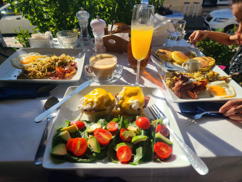 A delicious brunch eggs benedict with spinach, tomato and avocado during my gap year birthday