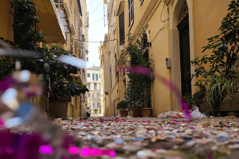 Corfu old town with streamers and sparkles scattered on the ground after a celebration