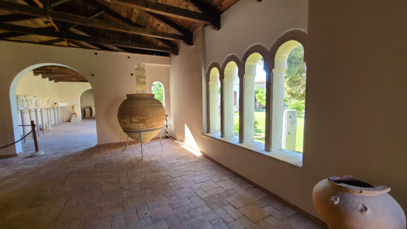 The museum in the monastery at Apollonia features white plaster walls and a wood ceiling.