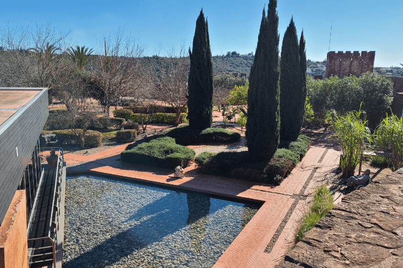 The castelo de silves cafe features a pond and garden inside the castle walls