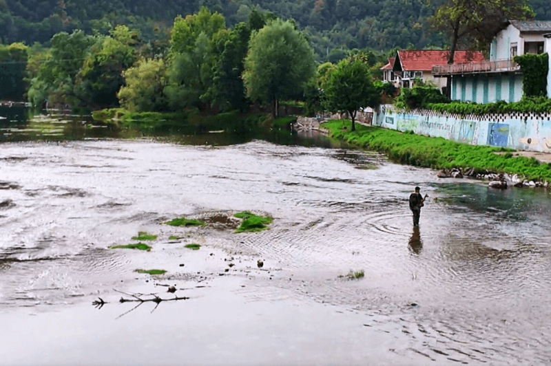 A man fly fishes in the Una River in Kulen Vakuf.
