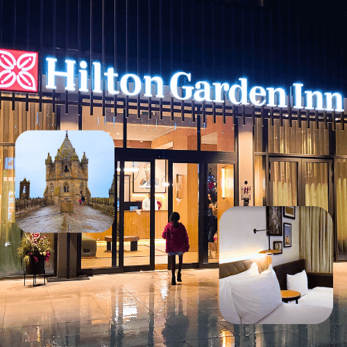 The front of the Hilton Garden Inn in Evora Portugal, lit up at night.